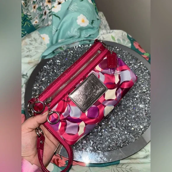 Coach Poppy Wristlet featuring a pink and purple geometric pattern. - Picture 7 of 9